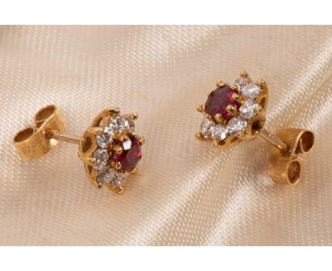 A pair of 18ct yellow gold diamond and ruby cluster earrings, the central round cut ruby surrounded by eight round diamonds, 
