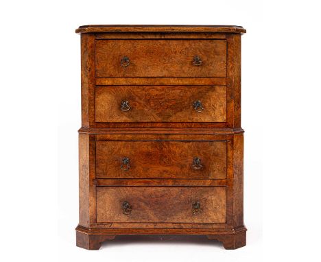 A miniature walnut chest on chest, 19th Century and later, the top with moulded edge, above four drawers flanked by chamfered