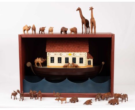 A cased model of Noah's Ark in a red painted and panelled case, the detailed painted ark with two doves painted to the gable 