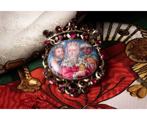 A 19th Century Continental enamelled brooch, the central oval enamel plaque depicting the three Kings and star of Bethlehem, 