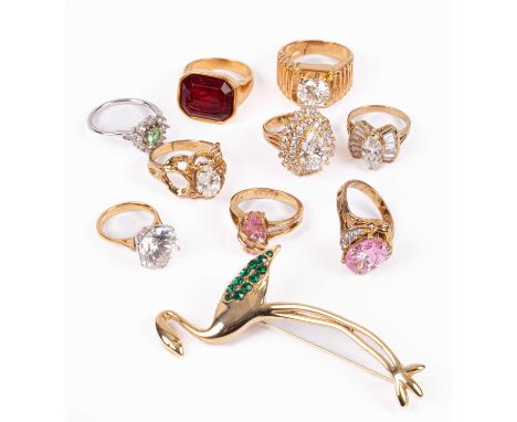 A collection of costume jewellery including assorted dress rings in yellow and white metal inset with pink, green, ruby colou