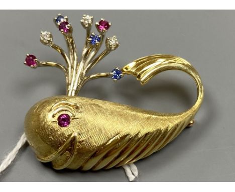 A novelty continental yellow metal (engraved 14k), ruby diamond and sapphire set 'happy' whale brooch, length 35mm, gross 11.