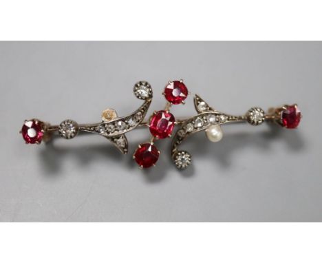 A yellow and white metal, ruby, diamond and seed pearl scrolling bar brooch (pearl missing), 46mm, gross 5.1 grams.