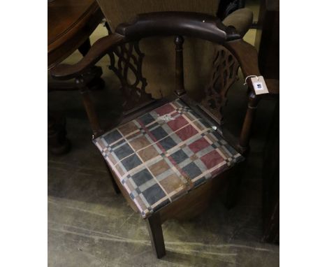 A George III mahogany corner elbow commode chair