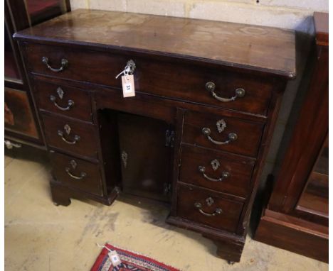 A George III walnut kneehole desk, width 90cm, depth 42cm, height 86cmCONDITION: The top is severely water stained and ring-m