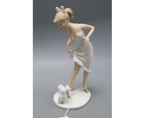 A Goebel figure of a woman and a poodle, height 23cmCONDITION: Some minor flaws in the manufacture including unglazed section