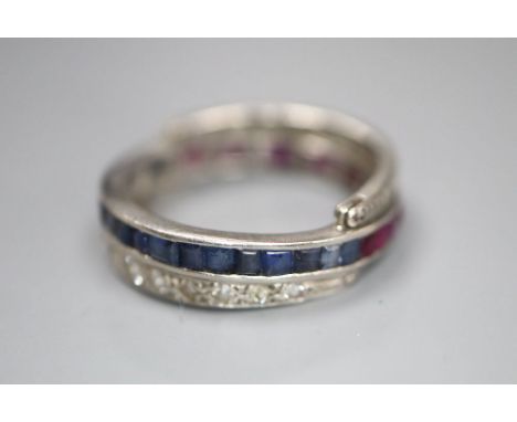 A white metal, diamond, ruby and sapphire swivelling eternity ring (ruby missing), size K, gross 5 grams.CONDITION: Two of th