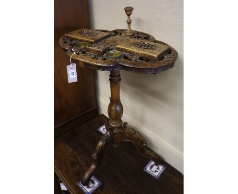 A 19th century Alpine carved fruitwood smoker's compendium, the quatrefoil top pierced and carved with eidelweiss and with li