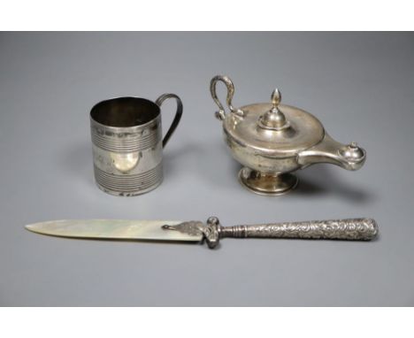 A George III reeded silver small mug, London, 1807, 6.3cm, an Edwardian Aladdin's lamp perpetual lighter and a paper knife.