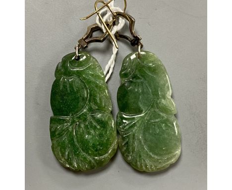 A pair of white and yellow metal, diamond chip set carved jade drop earrings, jade 35mm, gross 14.7 grams.