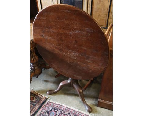 A George III mahogany tilt-top occasional table on tripod base (top repaired), diameter 77cm