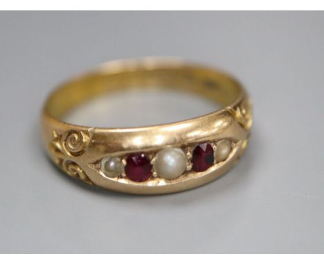 A late Victorian 15ct gold, graduated ruby and split pearl set five stone ring, size M/N, gross 2.8 grams.