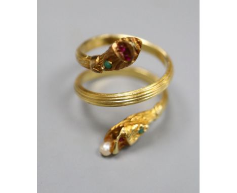 A Georgian style reeded yellow metal and gem set twin headed serpent ring, seed pear later added, size K/L, gross 7.3 grams.