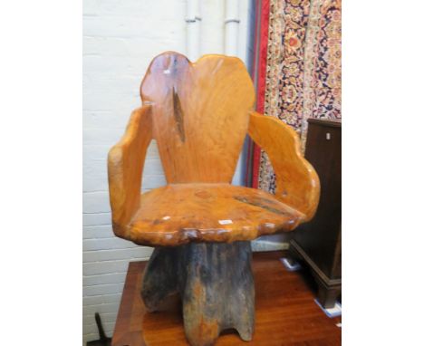 An unusual naturalistic chair, formed from a tree trunk 