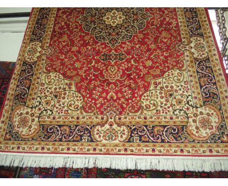 A Keshan carpet, on a red ground 2.3x1.6m 