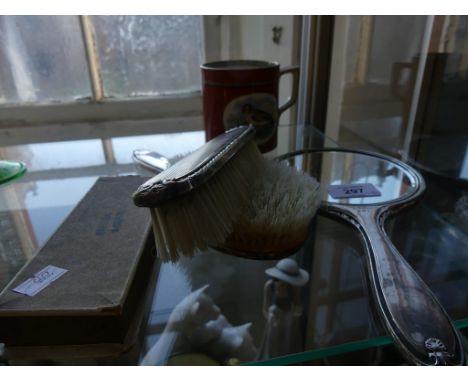 A mixed lot comprising a silver backed three piece dressing table brush and mirror set, a further cased silver spoon etc 