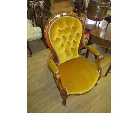 A Victorian gold upholstered button back show wood ladies armchair 