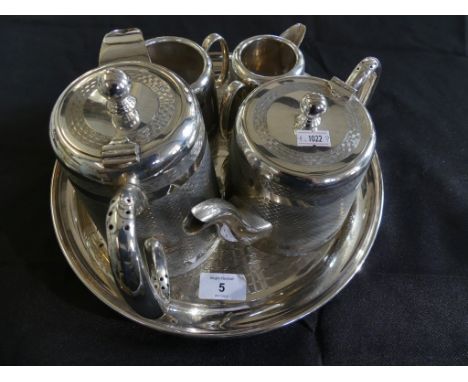 A silver-plated four piece tea service with accompanying tray, decorated with engined turned detail 