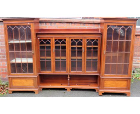 A large Edwardian mahogany display cabinet Formed of four sections, the side sections with single glazed doors to a shelved i