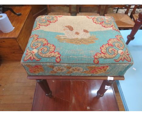 A Victorian mahogany footstool decorated with a tapestry top with design of a spaniel 