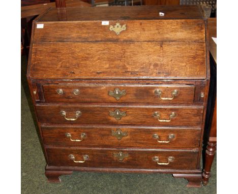 Georgian oak fall-front bureau with fitted interior above four long drawers, raised on bracket feet