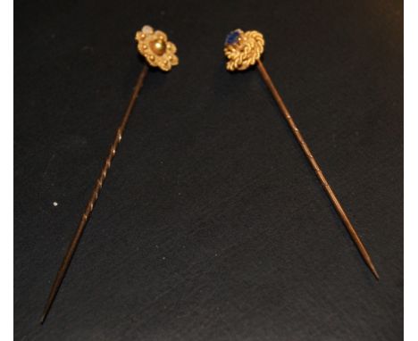 Two gold decorative stick pins plus a set of gold earrings 