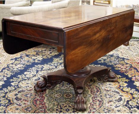 A Georgian mahogany sofa table raised on a quatrefoil base