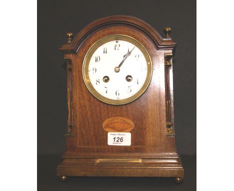 An Edwardian inlaid mahogany bracket clock, the circular enamelled dial with Arabic numerals, the brass movement with a chimi