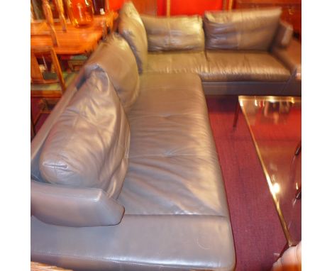 A 20th century contemporary designer corner sofa upholstered in green leather and raised on chromed supports 