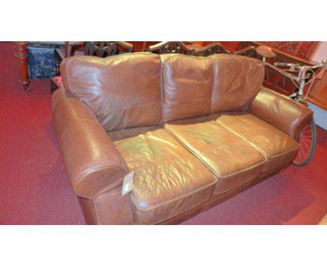 A contemporary designer three seater sofa upholstered in brown leather