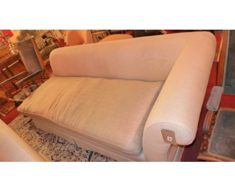 A contemporary designer three seater sofa upholstered in beige fabric on block supports 