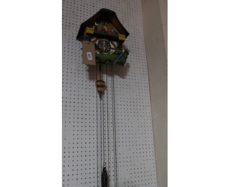 A Swiss design carved and painted cuckoo clock together with a Kingston pottery figure of a dog
