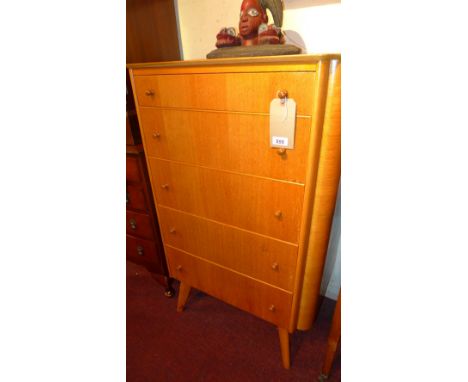 A light oak tall chest fitted five drawers on tapering supports