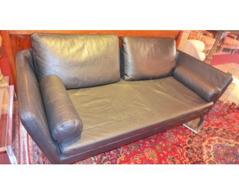 A Vitra sofa upholstered in black leather (one front foot missing)