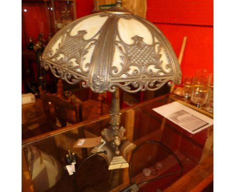 A Tiffany style table lamp with opaque glass shade and ornate column supports 