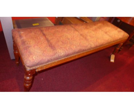 An Edwardian window seat with tapestry style fabric and raised on turned supports 