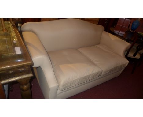 A David Seyfried camel back sofa upholstered in calico fabric raised on bun feet