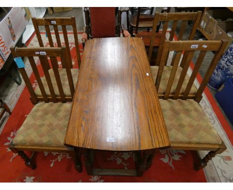 An oval drop leaf gate leg dining table, 150 x 110 cm, together with four chairs with drop in seats (5). 