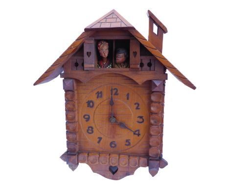 An usual Swiss / Black Forest cuckoo-style 'kissing' clock; the pendulum terminal modelled as a carved heart