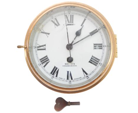 A mid-20th century brass-cased ship's wall-mounting clock - circa 1940s, white-enamel dial with Roman numerals and slow/fast 