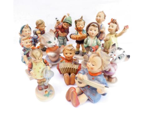 13 West German style hand-decorated porcelain figure models of young children and two cats including some Goebel examples (13