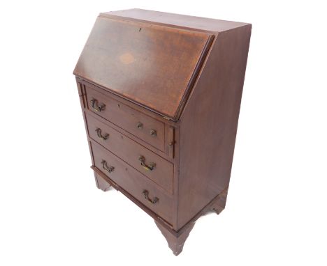 An Edwardian mahogany and satinwood crossbanded writing bureau of small proportions; the sloping fall with central marquetry 