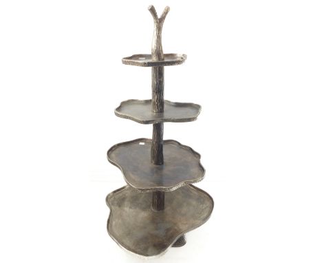 A heavy and unusual cast-iron etagere modelled as a vertical branch with four shaped concentric shelves modelled as thin trun