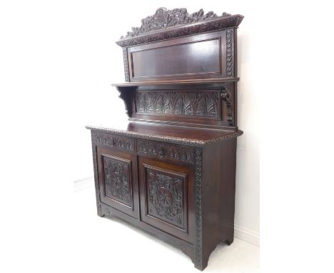 A late 19th century carved oak dresser: the pediment with a central incised scallop-shell motif flanked by scrolling acanthus