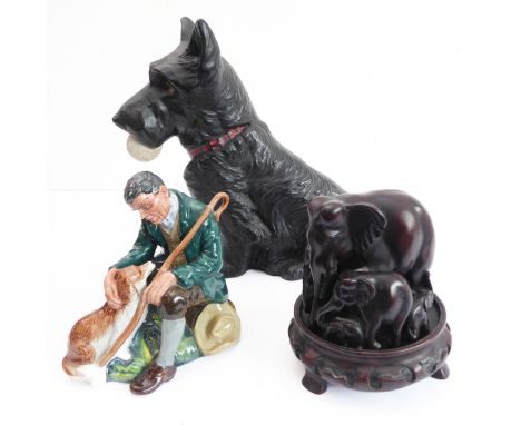 A large fireside pottery model of a Scottish Terrier holding a golf ball and a Royal Doulton figure, 'The Master' (damaged/re