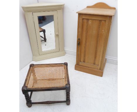 An early 20th century stripped oak bedside-style cabinet, a white-painted mirror-fronted wall-hanging cupboard and an early 2