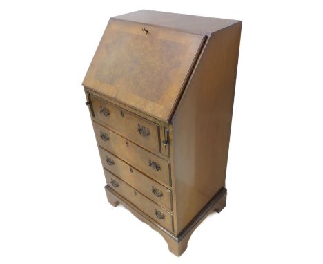 A Georgian style (mid 20th century) figured walnut writing bureau of small and slim proportions; the crossbanded angular fall