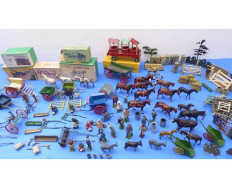 A toy farm made up of mostly mid-19th century metal farm figures and wooden farm buildings.&nbsp;The farm equipment to includ
