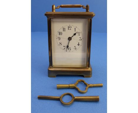 A French carriage clock; early 20th century, white enamel dial (cracked) with Arabic numerals (12cm high)