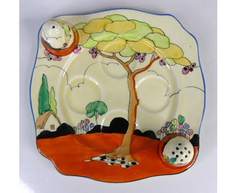 A 1930s Clarice Cliff Tulips pattern pottery egg-cruet dish with matching domed salt and pepper shakers, plate dia.17.5cm (on